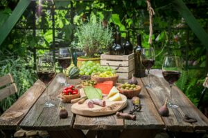 Garden table with cheese and wine Garden summer evening.